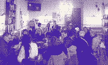 People talking around café tables at a Thursday exchange.